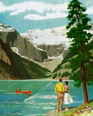 istock Couple Looking Out Onto a Mountain Lake 1328221952