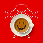 istock Cup of coffee with happy smiling face and silhouette of alarm clock 1328156770