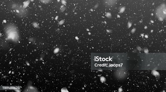 istock Falling Snowflakes in the Night 1181488623