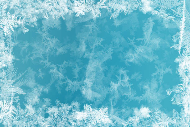 Frost patterns on frozen window as a symbol of Christmas wonder. Christmas or New year background Frost patterns on frozen window as a symbol of Christmas wonder. Christmas or New year background. frozen stock illustrations