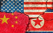 istock Grunge flags illustration of three countries with conflict and political problems (cracked concrete background) | China, USA and North korea 1367445841