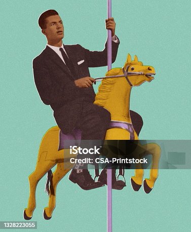 istock Man Riding a Carousel Horse 1328223055
