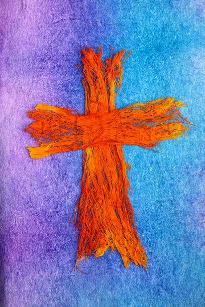 Mixed Media Fiber Cross "Orange and yellow fiber cross on a blue,  turquoise and purple painted background.  Done by contributor. Property release on file.Click to view more Christian images" cross shape photos stock illustrations
