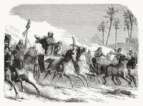 Pharaoh and his war army persecute the Israelites (Exodus 14). Wood engraving, published in 1862.