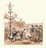 istock Scenes from a traditional English village fete, Children dancing around the maypole, Victorian 19th Century 1395957571