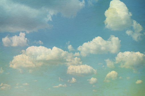 Sky with clouds in grunge textured style. Watercolor paper overlay background.