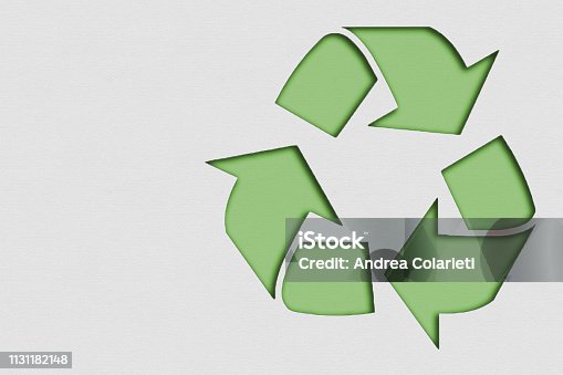 istock Symbol of recycled material made with paper on cardboard 1131182148