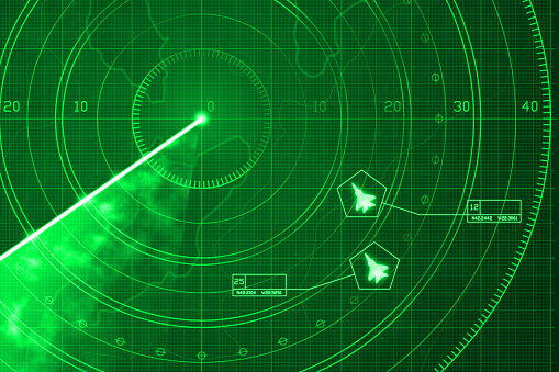 Two fighter jets icons identified and labeled on a radar simulation with green display, showing a glowing grid with coordinates and positioning numbers. Scanner axis is visible while spinning around the center. Warplane are targeted and identified with data and symbols, like in a video game. Copy space.