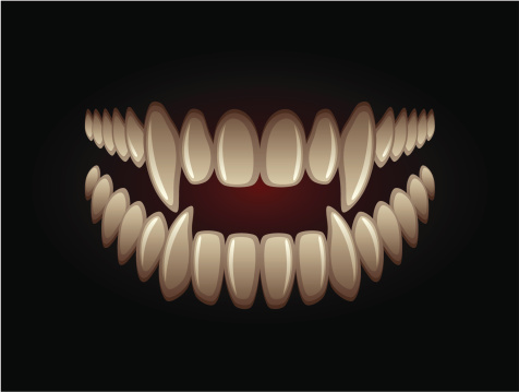White predatory teeth on a black background