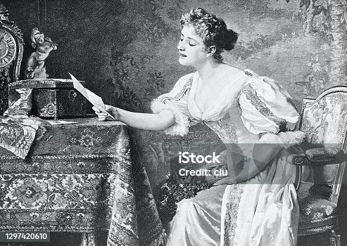 istock Young female beauty reading the love letter at the table 1297420610