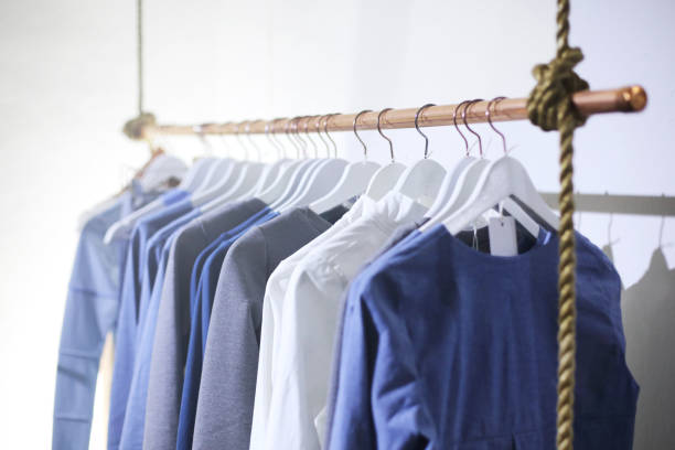 HANGERS WITH CLOTHES HANGERS WITH CLOTHES clothes rack stock pictures, royalty-free photos & images