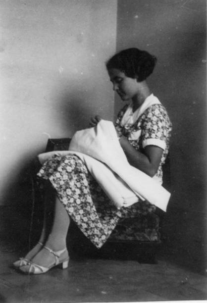 1930s. Florence Tuscany Italy young woman portrait Young woman weaving inside her apartment with elegant italian typical culture dresses. 1930s black and white film. Florence Tuscany. Italy florence italy photos stock pictures, royalty-free photos & images