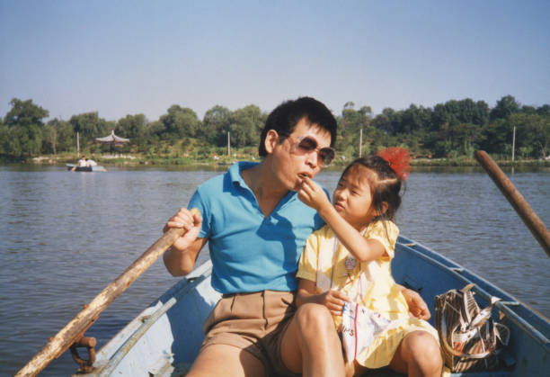 1980s China Father and daughter on the boat photos of real life 1980s China Father and daughter on the boat photos of real life chinese culture photos stock pictures, royalty-free photos & images