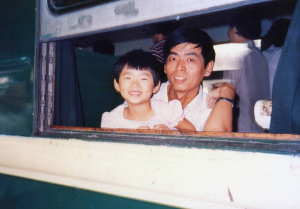 1980s Chinese Little Girl and Father on the Train Old Photo of Real Life 1980s Chinese Little Girl and Father on the Train Old Photo of Real Life chinese culture photos stock pictures, royalty-free photos & images