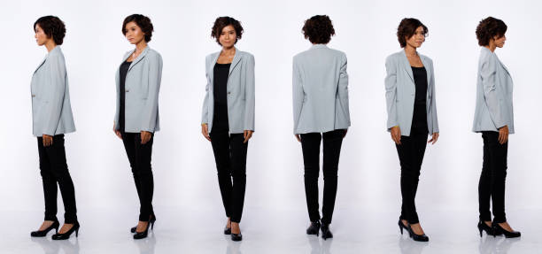 20s aziatische vrouw zwarte korte krul haar grijze pak jas broek profiel - staan stockfoto's en -beelden
