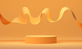 istock 3d mock up podium with flying orange ribbon on orange background. Abstract Modern platform for product or cosmetics presentation. Stylish contemporary backdrop. Render scene with geometric shapes. 1345449544