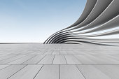 istock 3d render of futuristic architecture background with empty concrete floor, car presentation. 1353724898