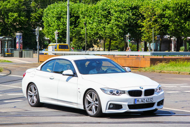 BMW (F33) 4-series Dresden, Germany - July 20, 2014: White sports car BMW (F33) 4-series in the city street. bmw stock pictures, royalty-free photos & images