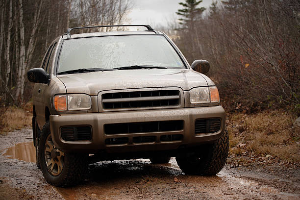 4x4 SUV Exploring off road on muddy trail stock photo
