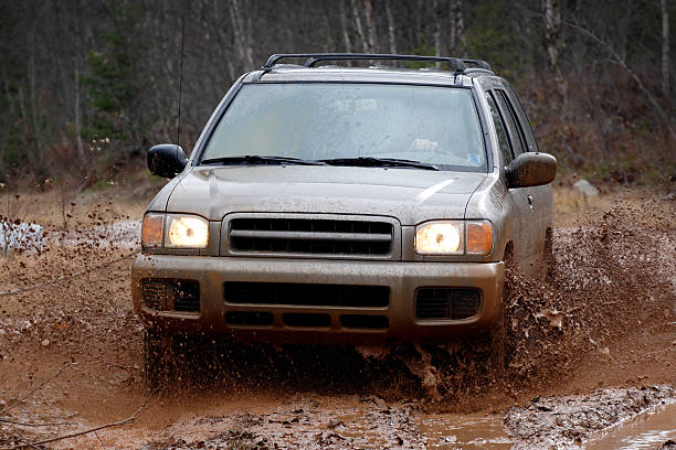 4x4 SUV in the mud splashing offroad stock photo