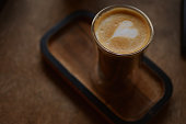 istock a cup of coffee with latteart on a wooden stand 1361871451