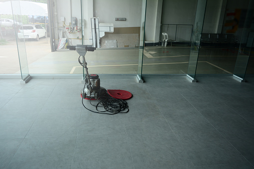 A Floor Scrubber Machine Put On The Floor In Gklasses Room While