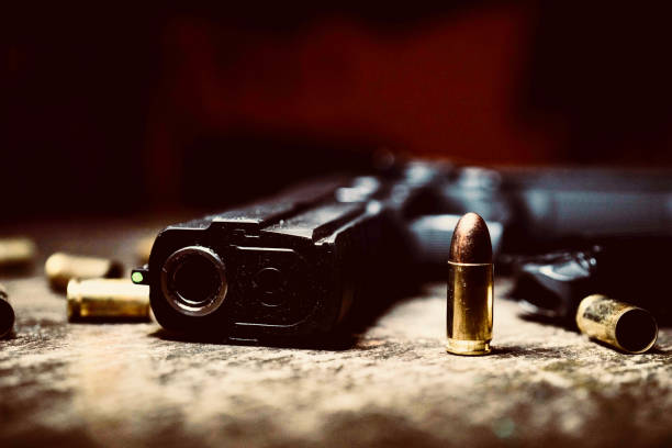 a handgun and it's bullet IV stock photo
