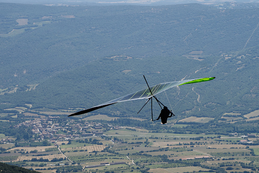 a hang glider flying above a town