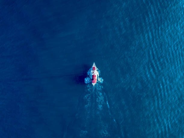 a lone yacht swim in deep blue ocean top view - aerial boat imagens e fotografias de stock