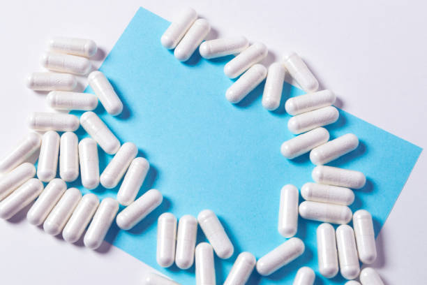 a lot of capsules pills on white background with copy space on the note for text stock photo