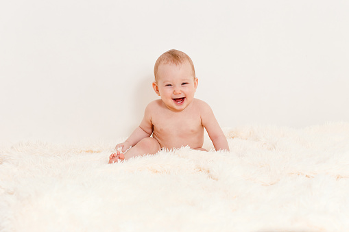 Naked Surprised Baby Girl Lying On White Bed Stock Image 