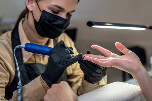 a new client came to a qualified nail artist to do a new manicure during quarantine. stock photo