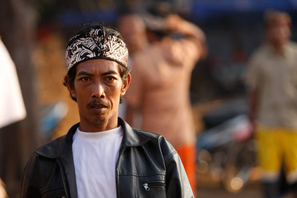 a portrait of a Balinese man using a head cap which is called Udeng Bali stock photo