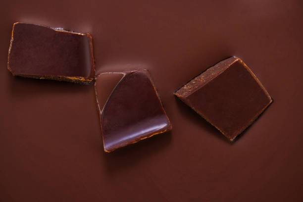 a slice of chocolate in liquid chocolate stock photo