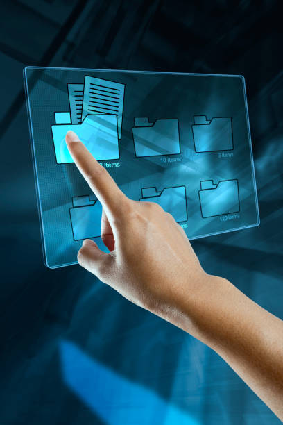 a woman hand is searching data in a folder on a digital screen stock photo
