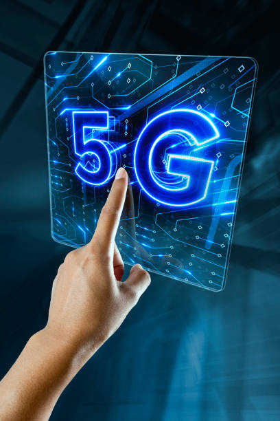 a woman hand is touching a digital screen with 5G sign stock photo
