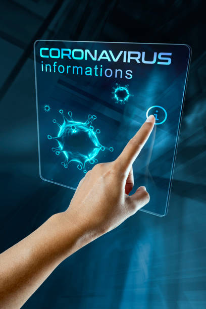 a woman's finger click information on the corona virus on a digital screen stock photo
