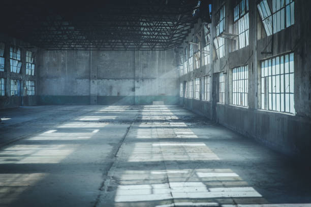 Abandoned Factory Building In Tyndall Effect Abandoned Factory Building In Tyndall Effect abandoned stock pictures, royalty-free photos & images