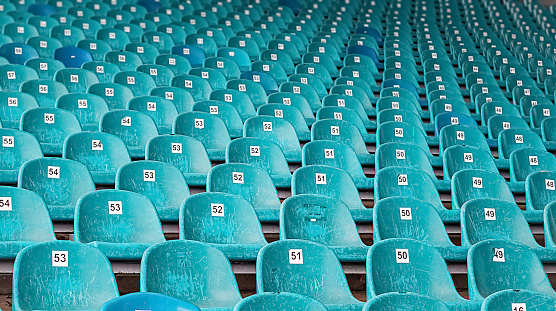 Abandoned premise with rows of old blue plastic seats