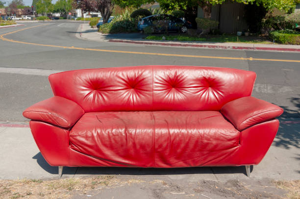 Abandoned red couch on the street stock photo