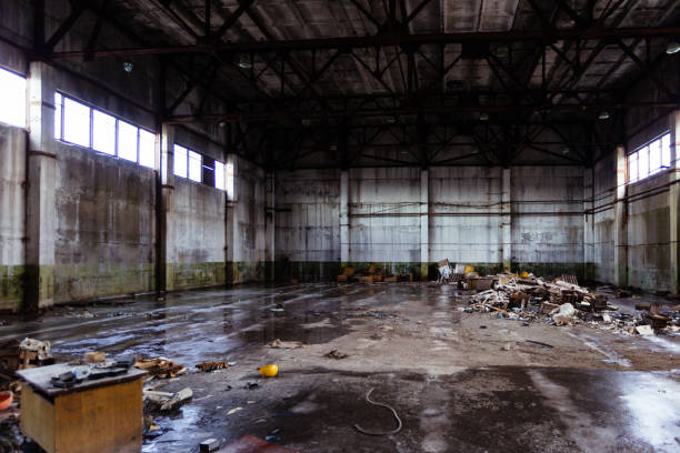 Abandoned ruined industrial hall with garbage stock photo
