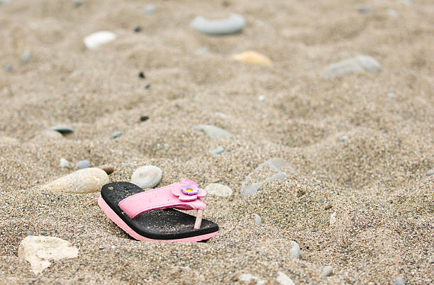 Abandoned Sandal on beach stock photo