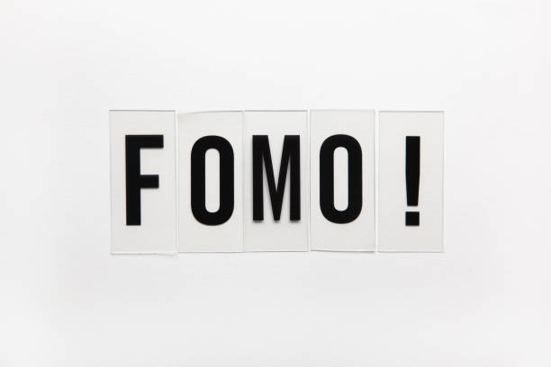 Abbreviation word FOMO on transparent plastic on white. It means Fear Of Missing Out, non-stop internet surfing. Concept social communication problem between people, digital detox. Flat lay Abbreviation word FOMO on transparent plastic on white. It means Fear Of Missing Out, non-stop internet surfing. Concept social communication problem between people, digital detox. Flat lay. fomo photos stock pictures, royalty-free photos & images