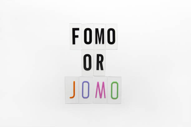 Abbreviation words FOMO, JOMO on transparent plastic on white background. FOMO means Fear Of Missing Out. JOMO - Joy Of Missing Out. Opposition, choice, social problem, digital detox. Flat lay Abbreviation words FOMO, JOMO on transparent plastic on white background. FOMO means Fear Of Missing Out. JOMO - Joy Of Missing Out. Opposition, choice, social problem, digital detox. Flat lay. fomo photos stock pictures, royalty-free photos & images