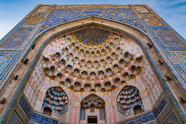 Abdulaziz Khan Madrasa Iwan Architecture Bukhara Uzbekistan Abdulaziz Khan Madrasa Iwan - Muqarnas Entrance Gate Islamic Architecture Detail from the year 1652 in the city of Bukhara opposite of the famous Ulugbek Medressa. Colorful Mosaic and Tiles aroung the Iwan into the Abdulaziz-Khan Medressa. Abdulaziz Khan Madrasa, Bukhara - Buxoro - Бухорo, Silk Road, Uzbekistan, Central Asia bukhara stock pictures, royalty-free photos & images