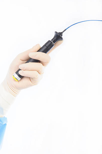 ablation cateter in the hand hand of female doctor holding an ablation catheter to treat cardiac arrhythmias reentry stock pictures, royalty-free photos & images