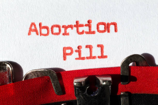 Abortion Pill concept Abortion pill typed on typewriter on red abortion pill stock pictures, royalty-free photos & images