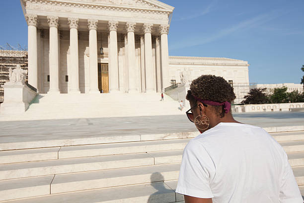 Abortion protester before Supreme Court building in Washington DC "Washington DC, USA - May 27, 2012: Abortion protestor with head bowed in front of the Supreme Court building in Washington DC." abortion protest stock pictures, royalty-free photos & images