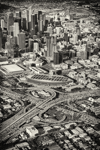 The skyscrapers of downtown Los Angeles, California, just beyond the 10 and 101 interchange during the typical daily rush hour traffic jam in black and white.