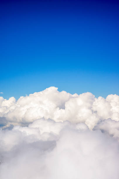 Above fluffy clouds Deep blue sky above fluffy white clouds. altocumulus stock pictures, royalty-free photos & images